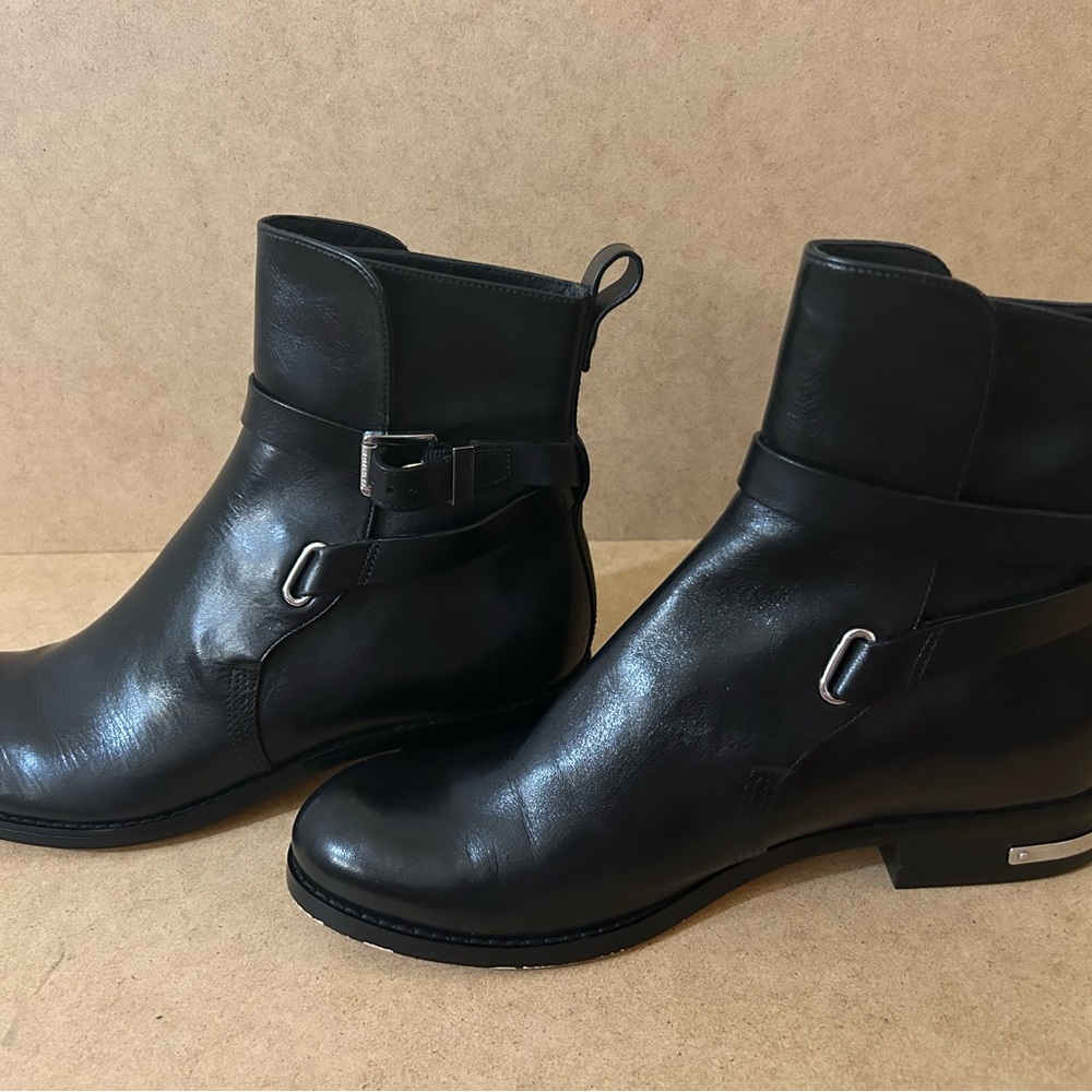 A pair of Blake leather shoes with belts around the ankles. Slip on shoes